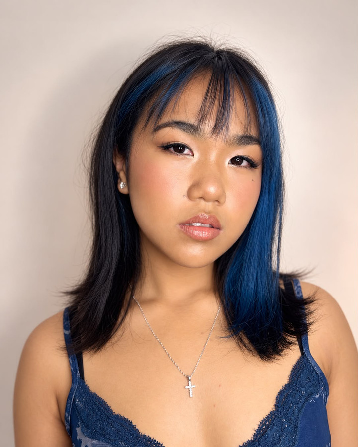 ABG glam: sharp winged liner and a glossed peach lip