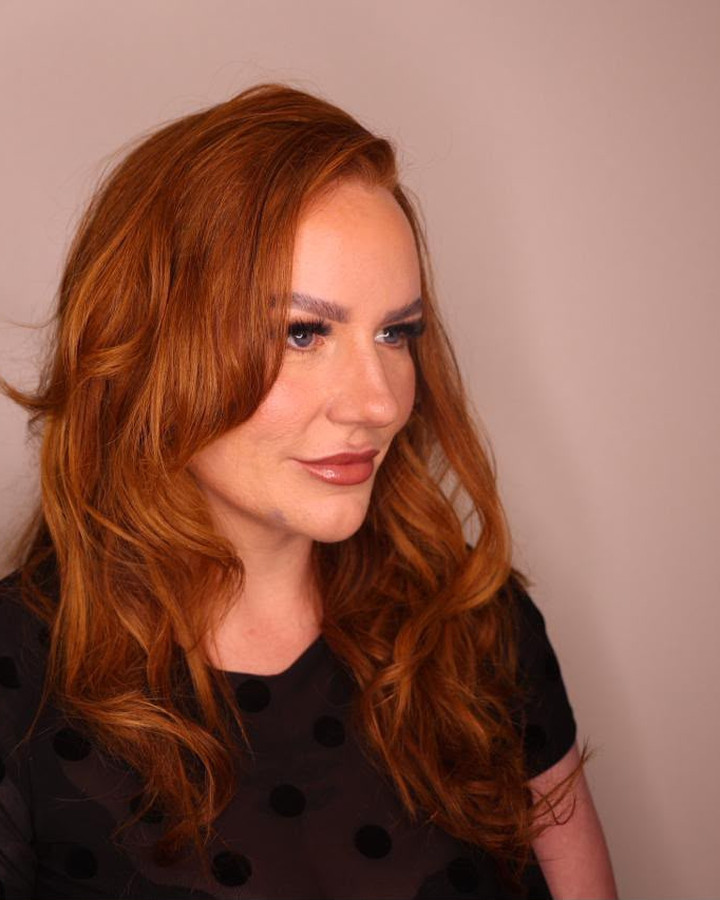 Full glam in profile: auburn waves and a nude lip