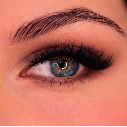 A brushed-up brow over a full-lashed blue eye