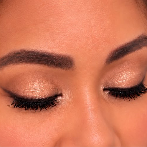 A gold shimmer lid, eyes closed